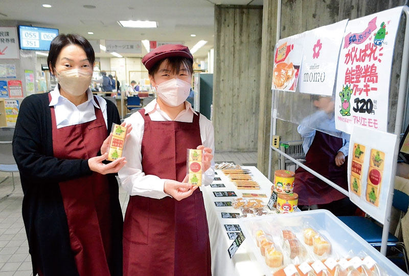チャリティークッキーを販売する事業所の利用者（右）と職員ら＝9日、埼玉県さいたま市中央区
