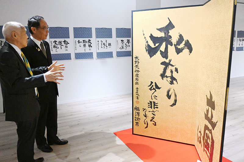 特別展示作品を鑑賞する大野元裕知事（右）と書家の金田石城氏＝2日午前、さいたま市大宮区のレイボックホール4階展示室