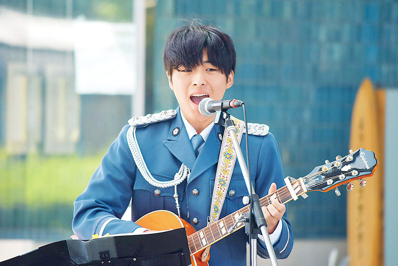 一日警察署長に委嘱され、歌を披露したKIYOHARUさん＝21日、寄居町役場前ロータリー