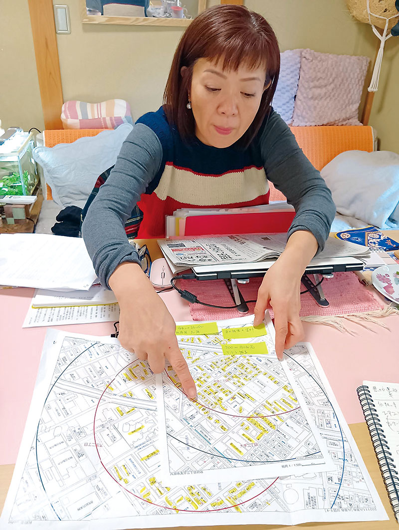 道路陥没事故現場からの距離と被害について説明する木下史江さん＝17日、八潮市内