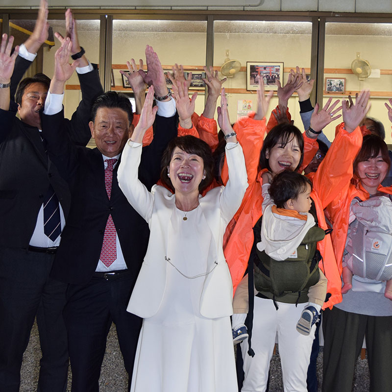 蓮田市長選で再選を果たし、支援者と万歳をして喜ぶ山口京子氏（中央）＝24日午後10時35分ごろ、蓮田市上の須賀神社