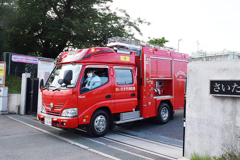 現場を出入りする消防車など＝10日午後4時12分、さいたま市西区の指扇中学校