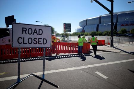 射殺された保守系政治活動家チャーリー・カーク氏の追悼式典が開かれるスタジアム付近の道路を封鎖する作業員ら＝２０日、米アリゾナ州（ロイター＝共同）