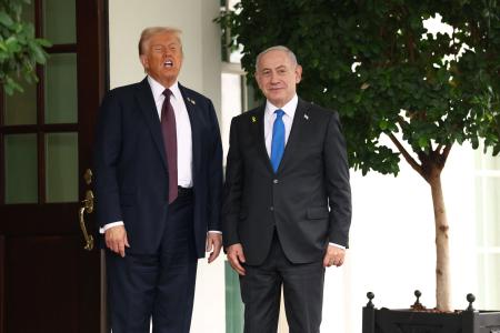 ２９日、米ホワイトハウスでイスラエルのネタニヤフ首相（右）を出迎えるトランプ米大統領（ロイター＝共同）