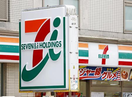 　セブン＆アイ・ホールディングスの看板とコンビニ店舗＝７月、東京都新宿区