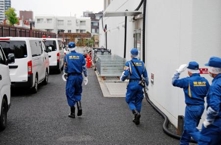 事故があった施設周辺を調べる警視庁の捜査員ら＝２２日午後０時３０分ごろ、防衛省