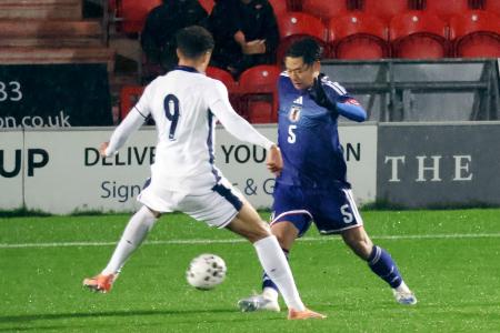 Ｕ―２０イングランド代表戦で競り合うＵ―２２日本代表の市原（右）＝ドンカスター（共同）