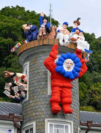 大阪・関西万博のキャラクター「ミャクミャク」を思わせるコスチュームで登場した「世相サンタ」＝１９日午前、神戸・北野の異人館「うろこの家」