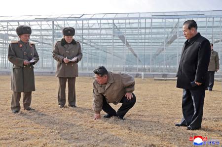 北朝鮮北西部・新義州周辺で完成間近の温室農場を視察する金正恩朝鮮労働党総書記（左から３人目）＝２６日（朝鮮中央通信＝共同）