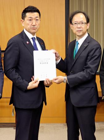 赤間二郎防災担当相（左）に要望書を手渡す大分県の佐藤樹一郎知事＝２７日午後、内閣府