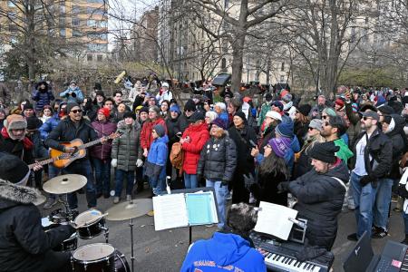 米ニューヨーク・セントラルパークの広場で、ビートルズのナンバーを合唱するファンら=8日(共同)