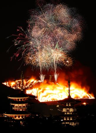 古都奈良の夜空を彩る冬の伝統行事「若草山焼き」。手前は薬師寺の西塔（左）と東塔＝２４日（午後６時１５分から７時１６分までの画像１９枚を合成）
