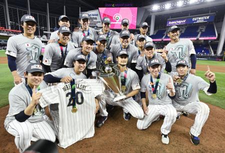２０２３年３月、ＷＢＣで優勝し、トロフィーを手にしたダルビッシュを中心に記念写真に納まる投手陣ら＝マイアミ（共同）