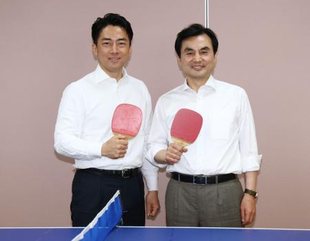 会談後、卓球のラケットを手に写真に納まる小泉防衛相（左）と韓国の安圭伯国防相＝３０日午後、神奈川県の海上自衛隊横須賀基地（代表撮影）