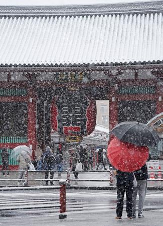 雪が降り続く東京・浅草寺の雷門前＝８日午前