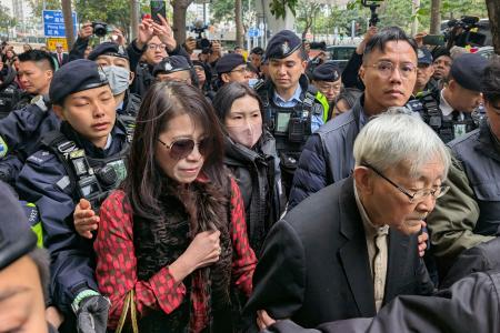 裁判所を出る蘋果日報の創業者、黎智英氏の妻（手前左）＝９日、香港（共同）