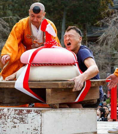 京都・醍醐寺で行われた「餅上げ力奉納」の男性の部で優勝した西田享さん=23日