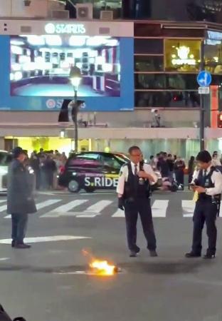 東京・渋谷駅前のスクランブル交差点で上がる炎＝３日夜（目撃者提供）