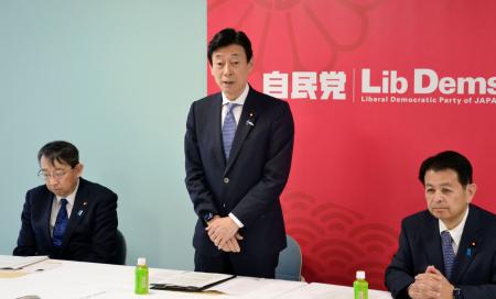 自民党本部で開かれた選対打ち合わせ会であいさつする西村選対委員長（中央）＝８日午後、東京・永田町