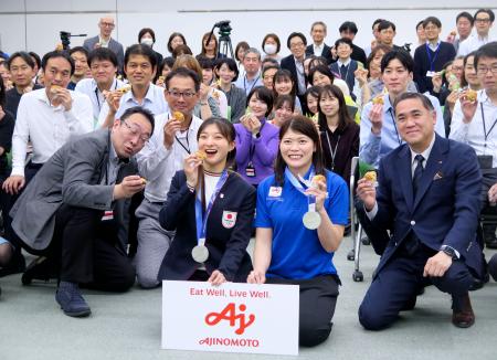 味の素本社を訪れ、社員らと記念撮影に応じるフィギュアスケート女子の坂本花織（中央左）＝２３日、東京都内