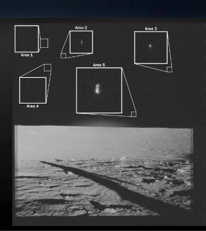 宇宙船アポロ12号の着陸地点から撮影した月面の画像。月の地平線より上側に光る点のようなものが複数見える(米国防総省提供)
