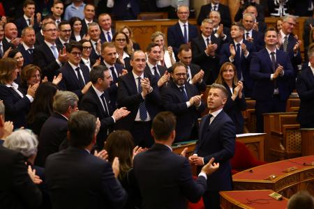 ９日、ハンガリー議会で拍手を受けるマジャル新首相（手前右）＝首都ブダペスト（ロイター＝共同）
