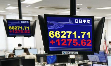 初めて６万６０００円台に乗せ、取引時間中の最高値を更新した日経平均株価を示すモニター＝２７日午前、東京都港区の外為どっとコム