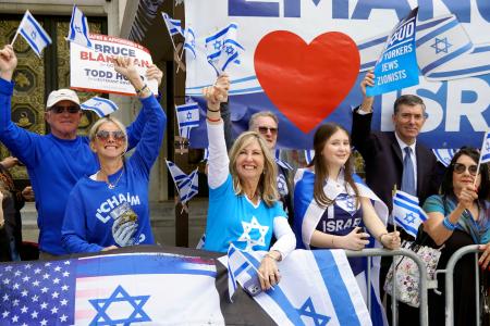 　イスラエルへの連帯を示すパレードで、沿道から手を振る人たち＝５月３１日、米ニューヨーク・マンハッタン（共同）