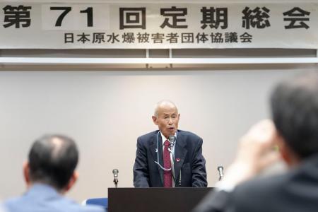 日本被団協の定期総会であいさつする箕牧智之代表委員＝１７日午後、東京都内