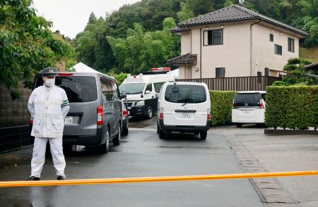 男性２人の遺体が見つかった住宅付近を警戒する警察官＝２６日午後１時７分、島根県出雲市
