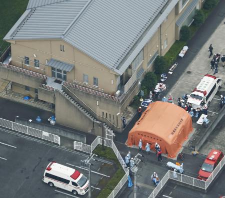 ２０１６年７月、入所者らが殺傷される事件があった知的障害者施設「津久井やまゆり園」で対応する救急隊員や関係者ら＝相模原市