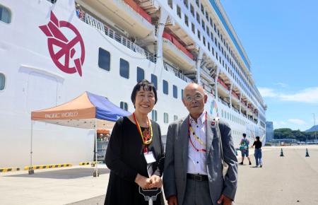 寄港した世界一周クルーズ船の前に立つ田中稔子さん(左)と広島県被団協の佐久間邦彦理事長=28日午後、広島市