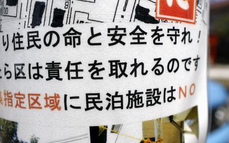 東京都内の住宅街に掲示された民泊施設に反対する張り紙=8月