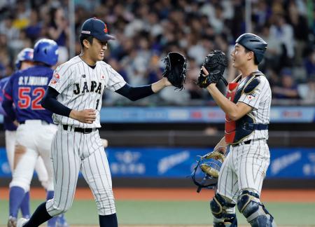 台湾戦の３回、ピンチを切り抜けタッチを交わす織田（左）と山田＝台北（共同）