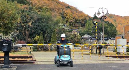 電動車いすが踏切から出られなくなる事故のイメージ（ＮＩＴＥ提供）