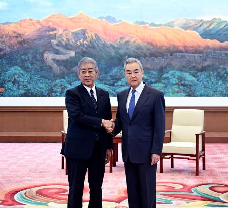 中国の王毅外相（右）と握手する岩屋前外相＝２８日、北京（中国外務省のホームページから、共同）