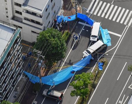 発砲事件があった神戸市中央区の現場周辺を調べる捜査員＝３０日午後（共同通信社ヘリから）