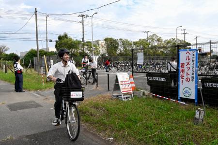 ＪＲ長浦駅付近で自転車を運転するシェアサイクル利用者＝１４日午前、千葉県袖ケ浦市